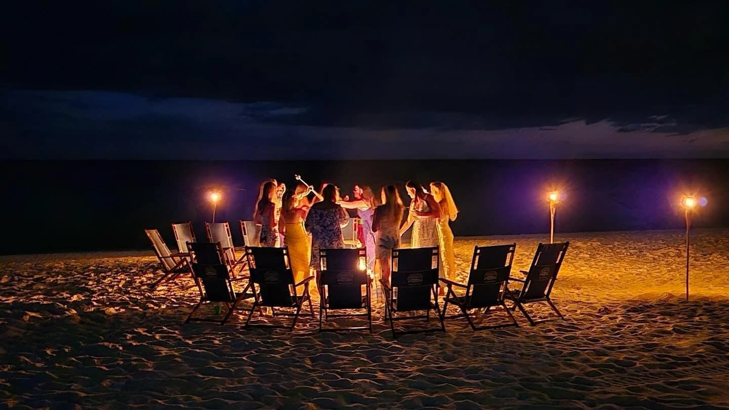 Friends enjoying a beach bonfire